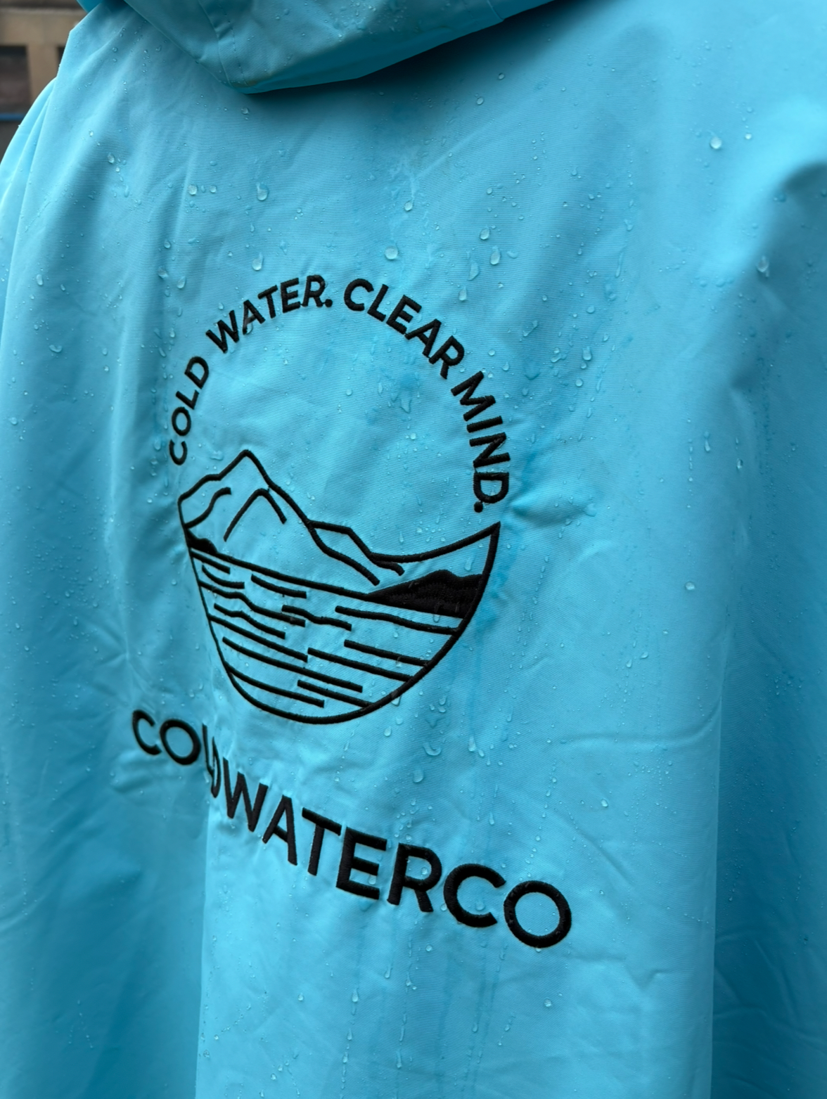 Close up detail of embroidery on blue changing robe