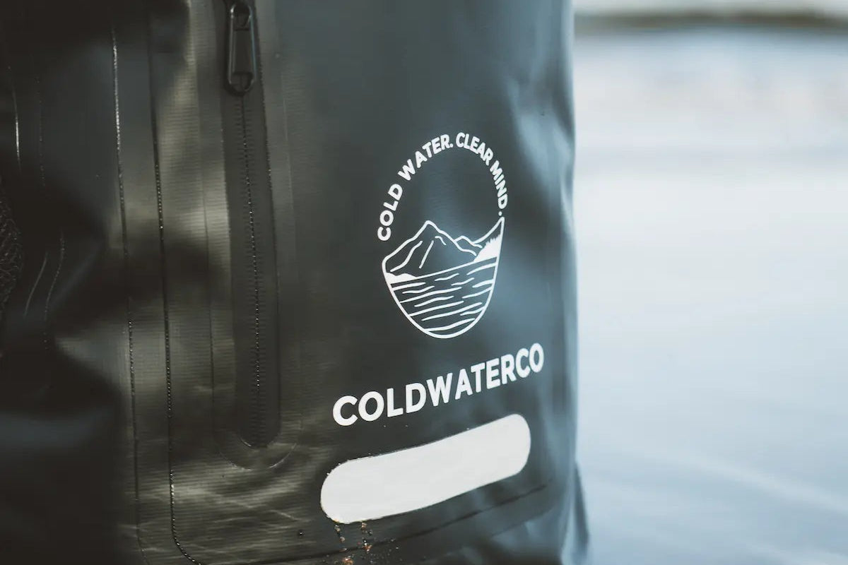 Black backpack with 'Coldwater Co' logo on a reflective surface