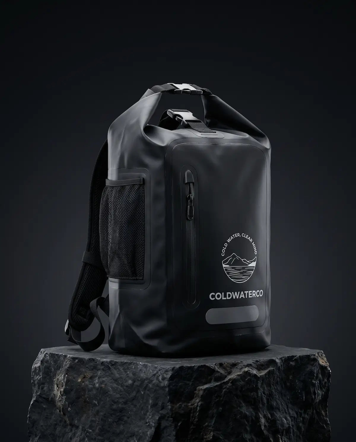 Black waterproof backpack with a visible brand logo(ColdWaterCo) on a dark background