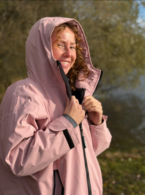 Woman outdoors in pink changing robe