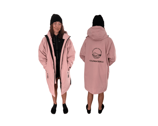 Woman in pink changing robe against white background