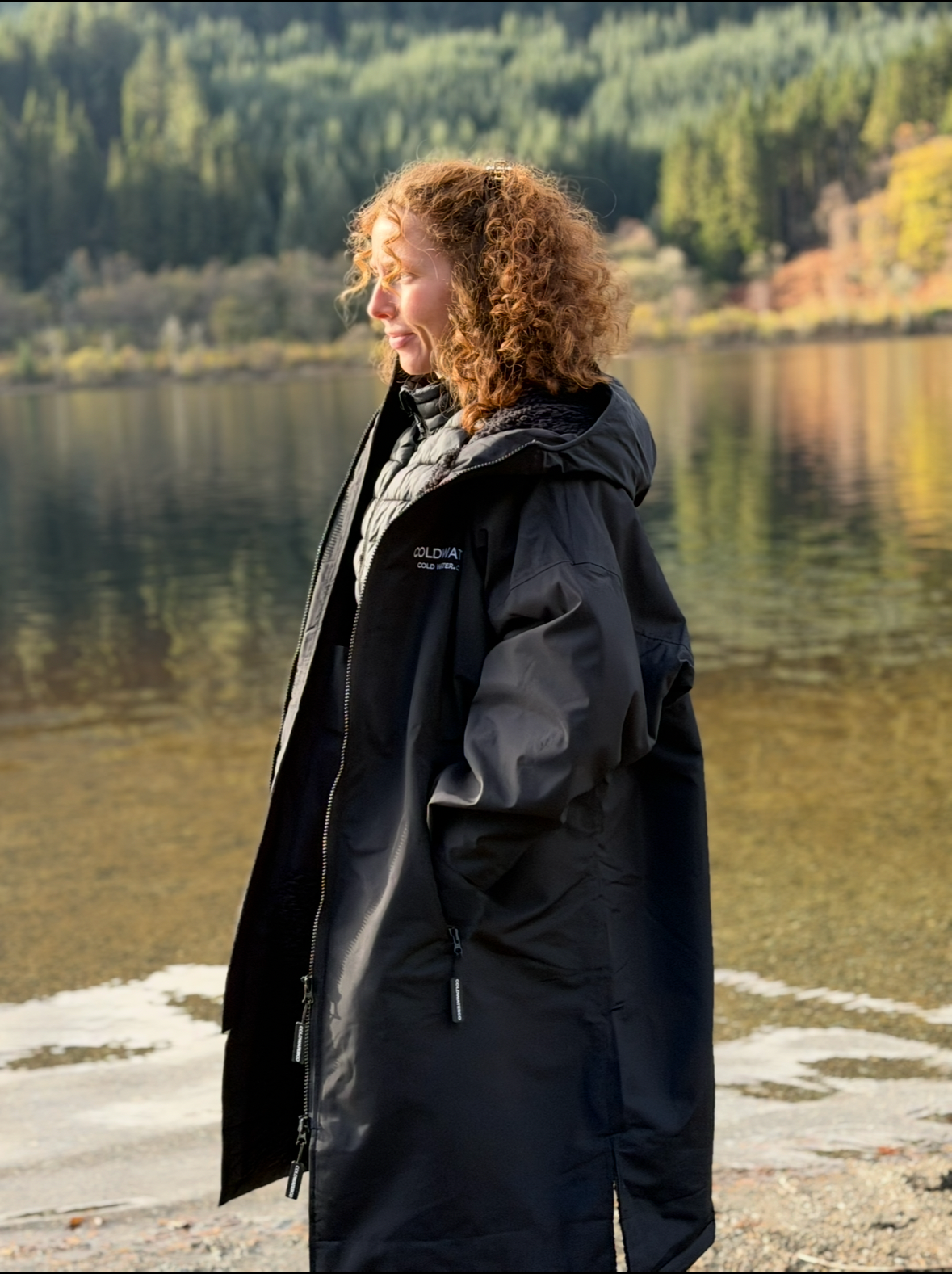 Woman wearing Coldwaterco changing robe near water