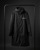 Black coat with a brand logo on a dark background