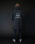 Man in black ColdWaterCo changing robe studio photo