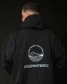 Man in pink ColdWaterCo changing robe, studio photograph