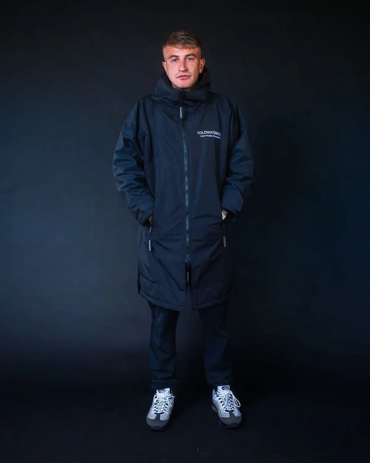 Man in black ColdWaterCo changing robe studio photo