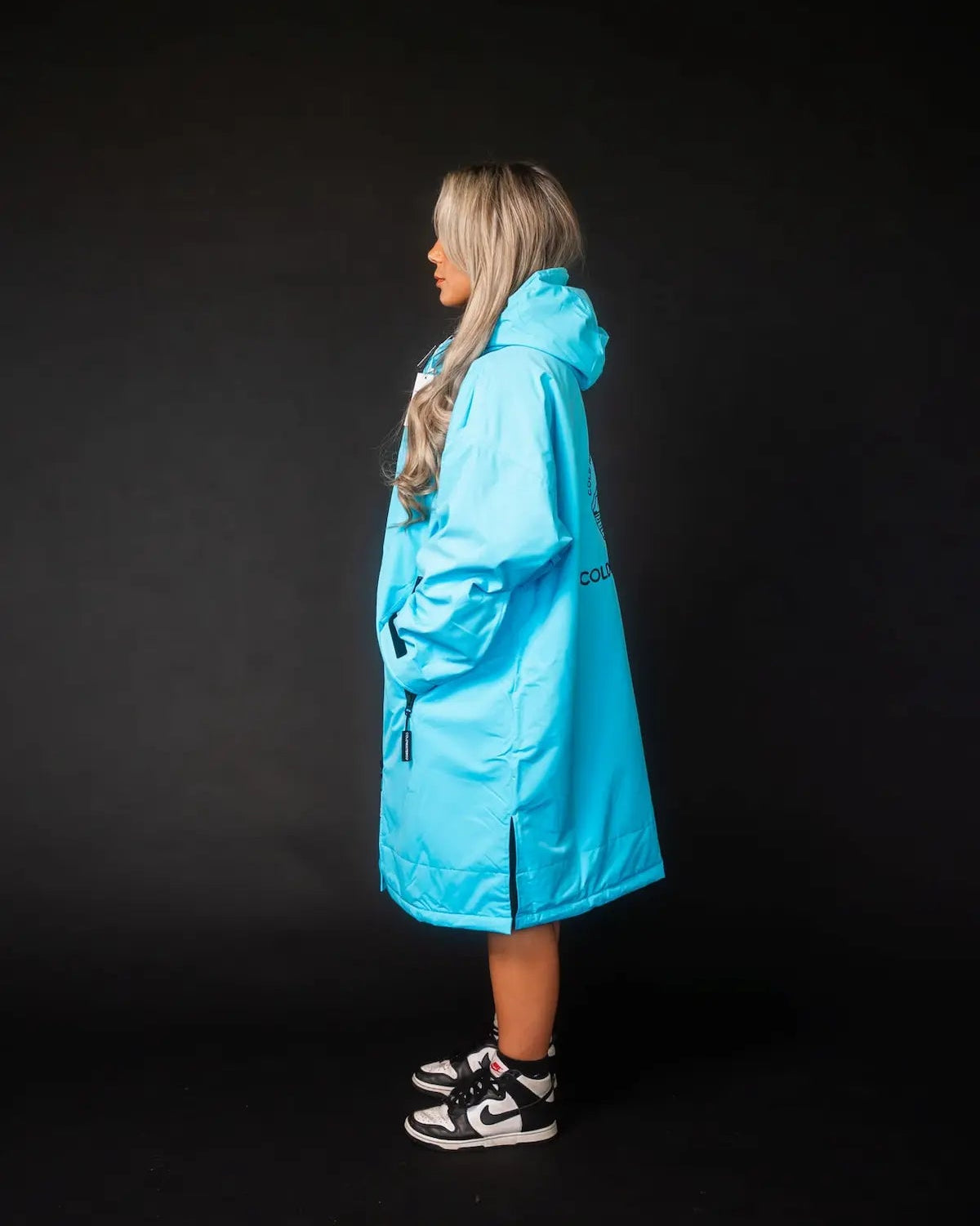 Lady in blue ColdWaterCo changing robe studio photo