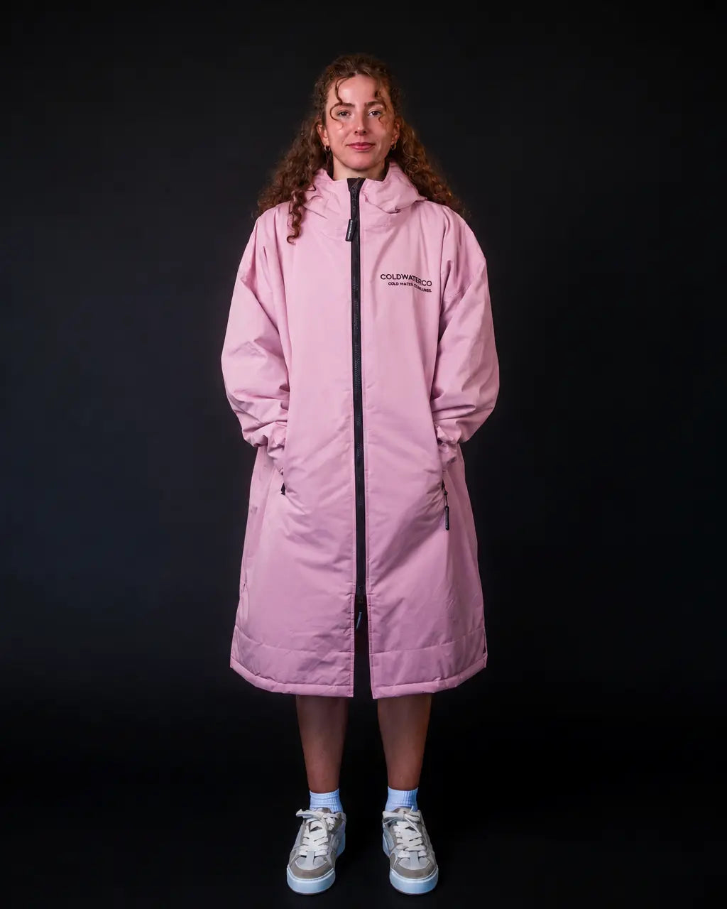 Lady in pink ColdWaterCo changing robe, studio photograph