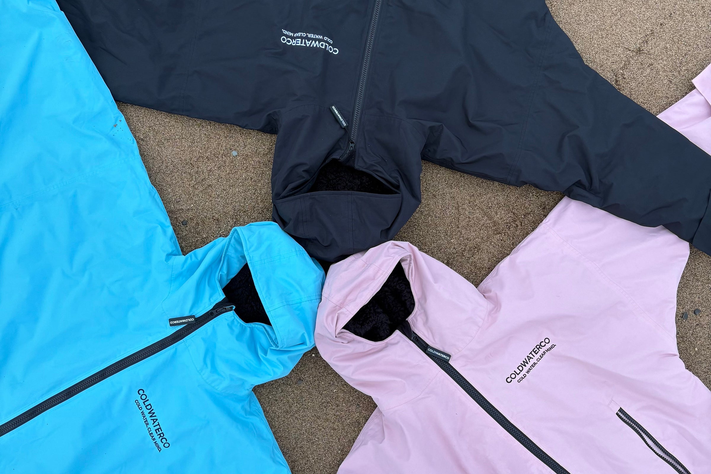 three robes laying in the sand